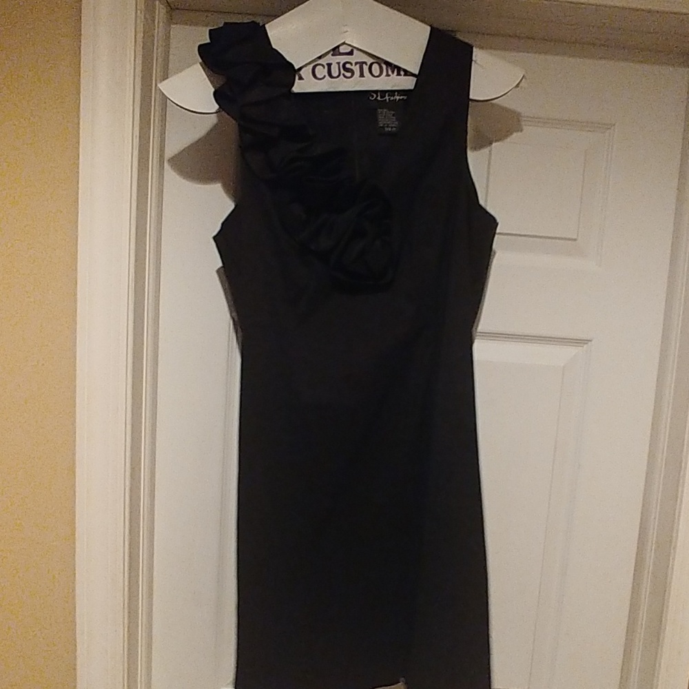 Black A-line dress with shoulder ruffle